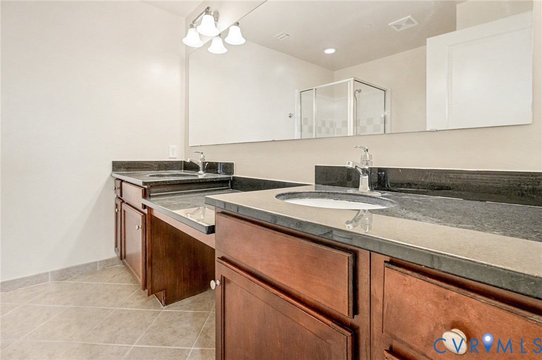 1101 Haxall Point, Unit U711 Richmond, VA 23219 - Photo 16 of 47 a kitchen with stainless steel appliances granite countertop a sink a stove and a refrigerator