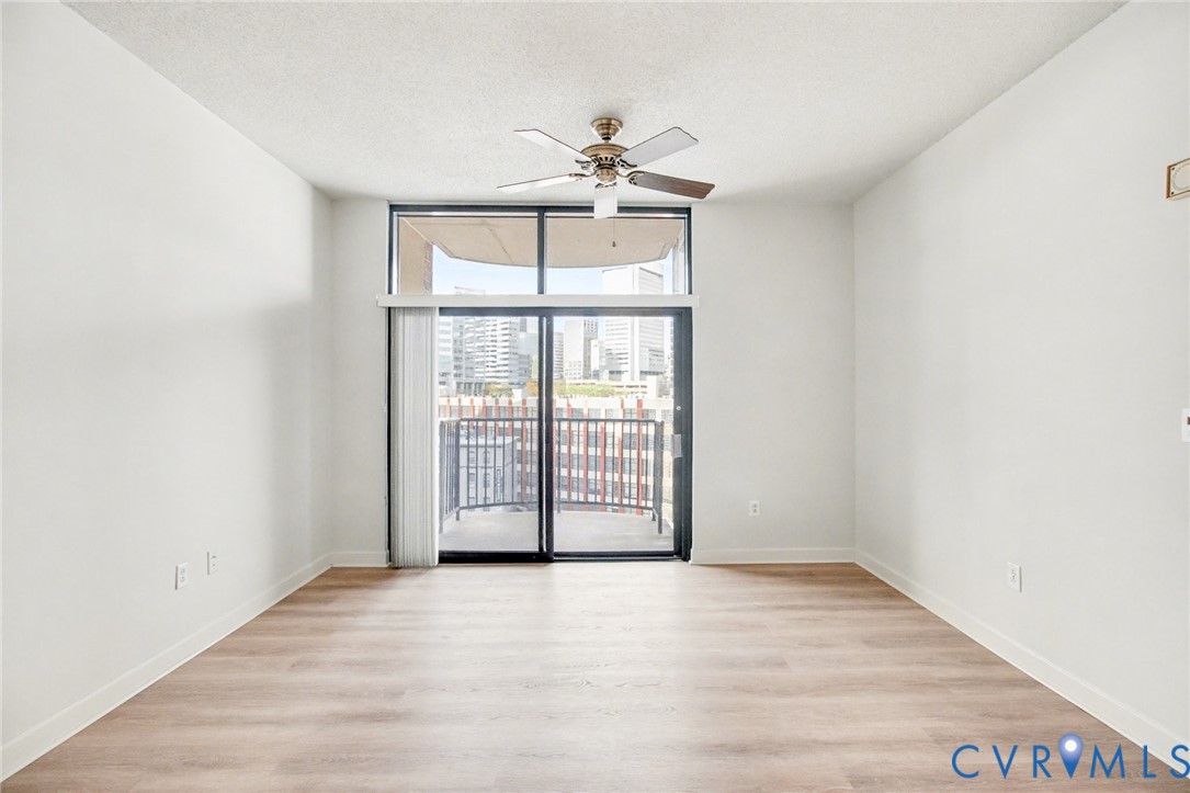 1101 Haxall Point, Unit U711 Richmond, VA 23219 - Photo 2 of 47 wooden floor in an empty room with a window