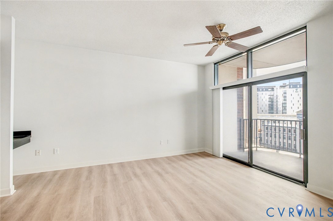 1101 Haxall Point, Unit U711 Richmond, VA 23219 - Photo 3 of 47 an empty room with wooden floor fan and windows