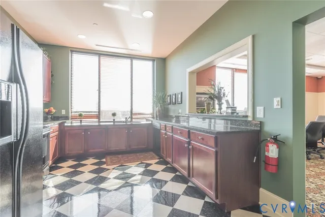 a kitchen with stainless steel appliances granite countertop a refrigerator and a sink