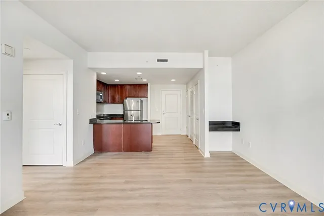 a view of kitchen with refrigerator and window
