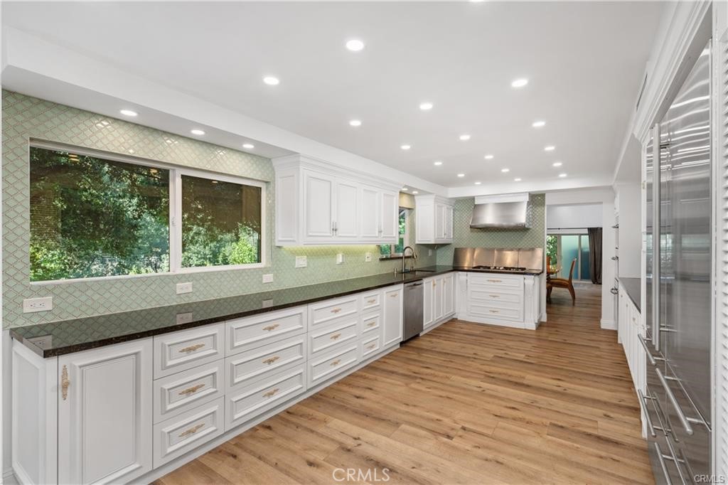119 Bell Cyn Road Bell Canyon, CA 91307 - Photo 21 of 39 a large kitchen with kitchen island a large counter top space a sink stainless steel appliances and cabinets