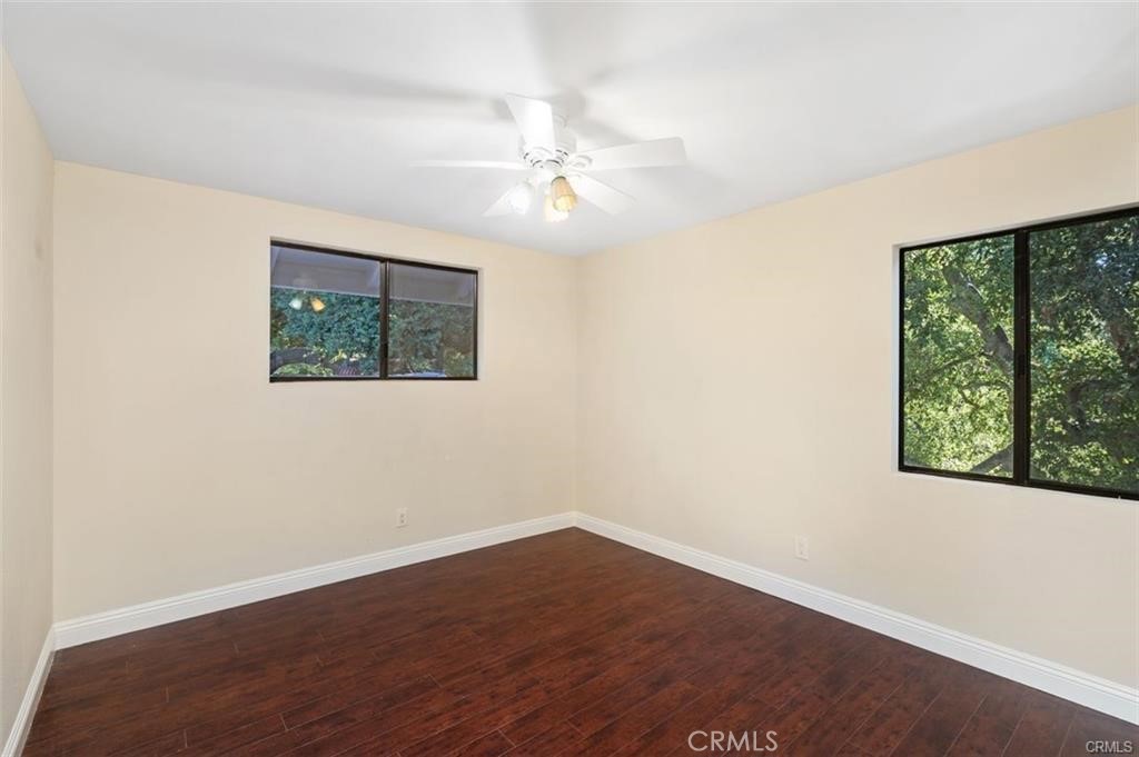 119 Bell Cyn Road Bell Canyon, CA 91307 - Photo 30 of 39 an empty room with wooden floor fan and windows