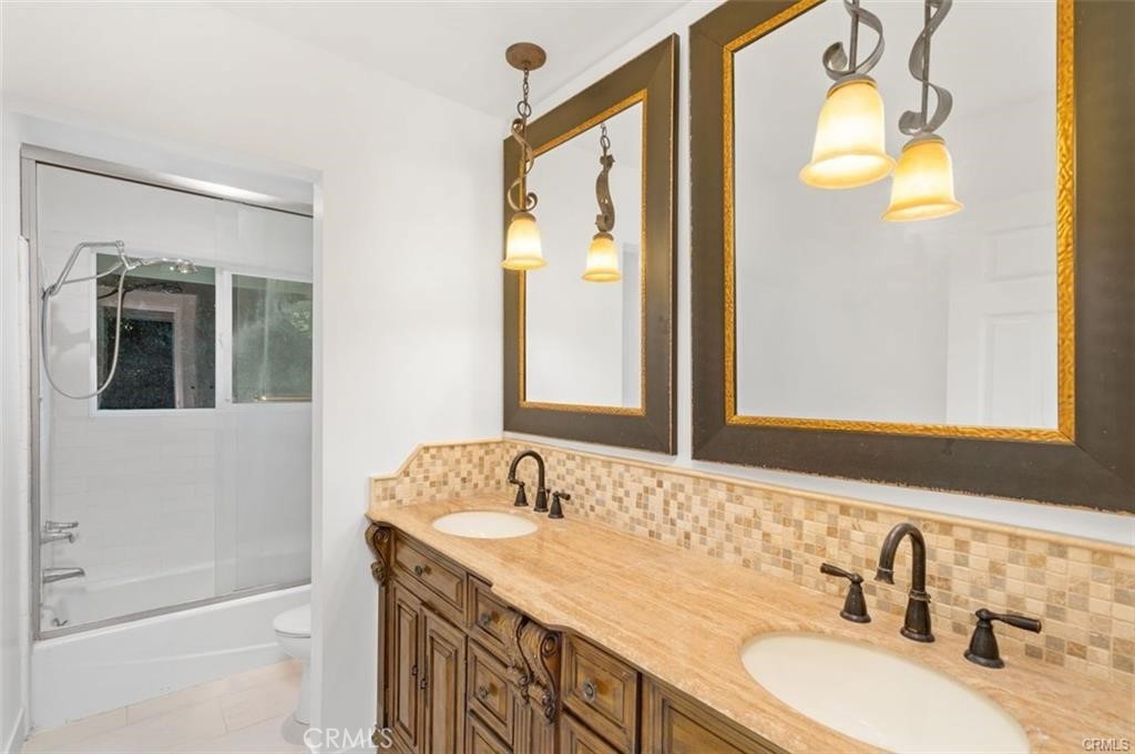119 Bell Cyn Road Bell Canyon, CA 91307 - Photo 33 of 39 a bathroom with a granite countertop sink and a mirror