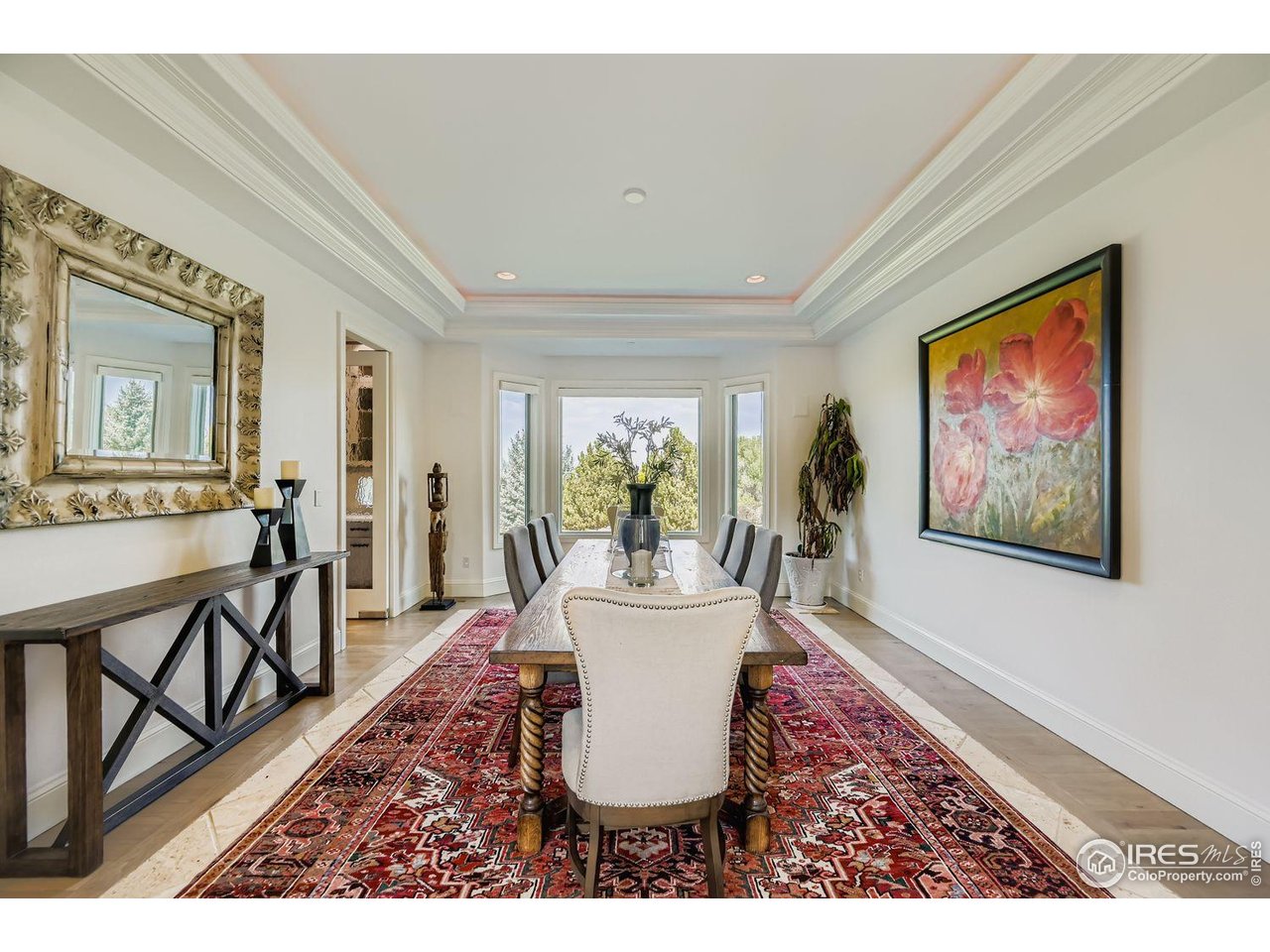 8001 Fairview Road Boulder, CO 80303 - Photo 15 of 49 a living room with furniture a dining table and a painting on the wall