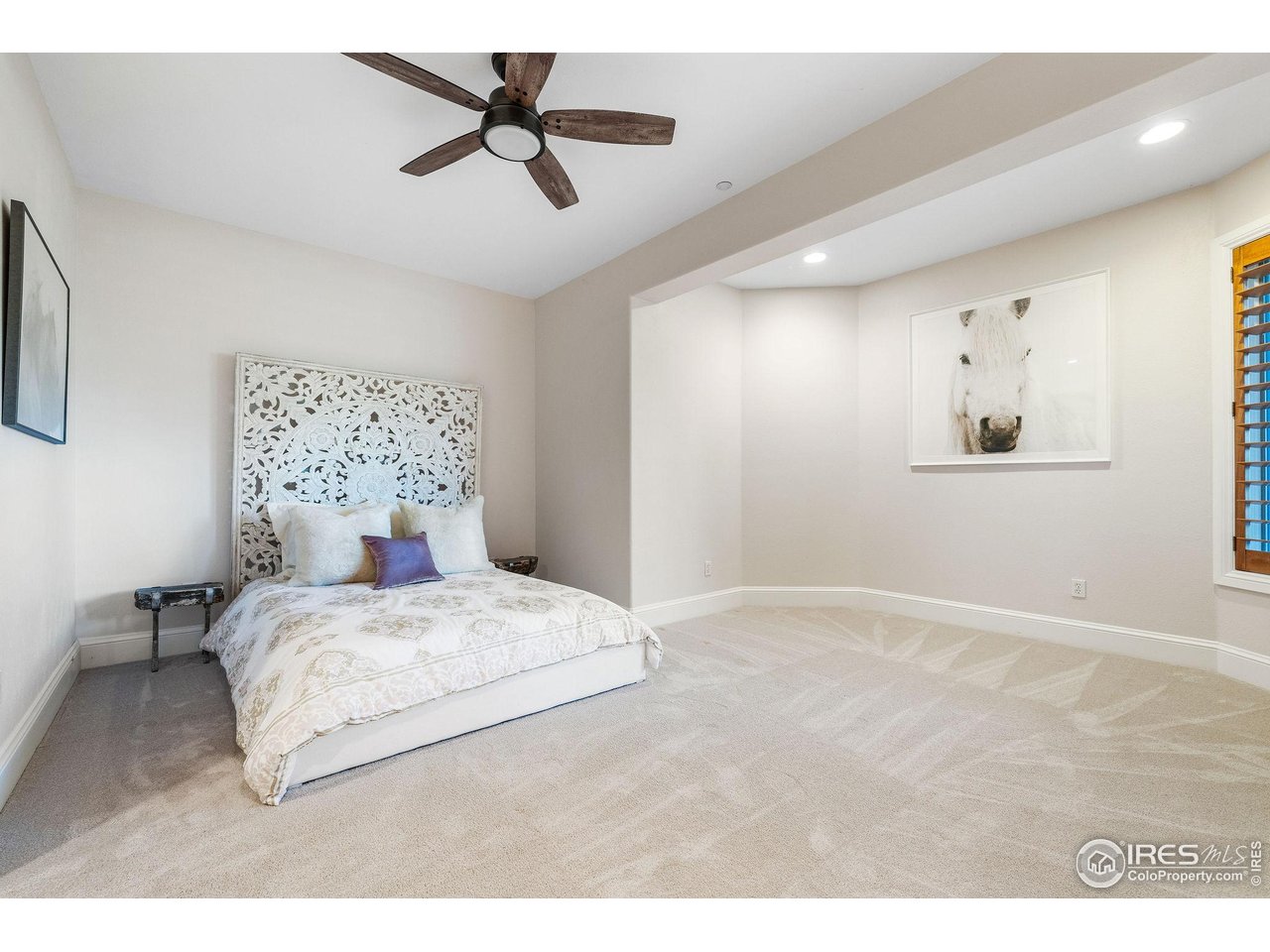 8001 Fairview Road Boulder, CO 80303 - Photo 32 of 49 a bedroom with a large bed and a chandelier