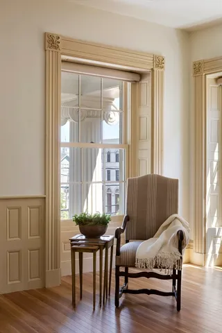 a dining room with furniture and wooden floor