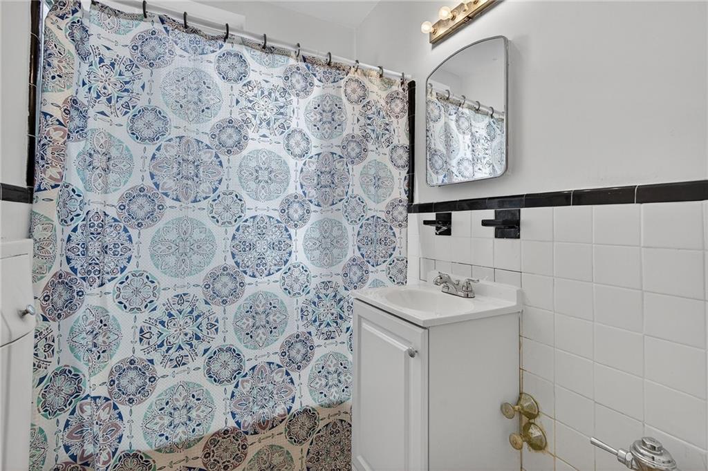 6801 Shore Road, Unit 2N Brooklyn, NY 11220 - Photo 11 of 16 a bathroom with a sink and a mirror