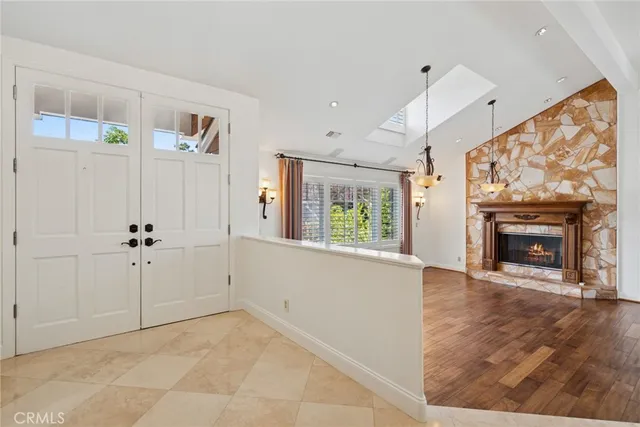 a view of an empty room with a fireplace and a window