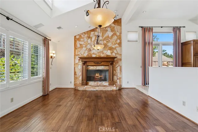 a view of an empty room with a fireplace and a window