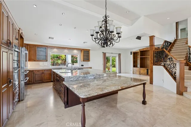 a kitchen with stainless steel appliances granite countertop a stove oven and a refrigerator