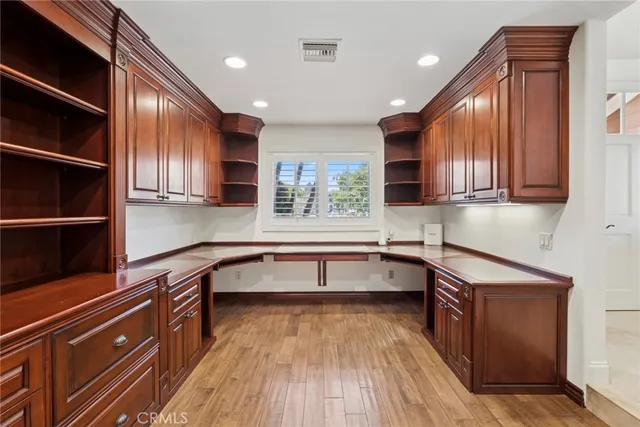 a kitchen with stainless steel appliances granite countertop wooden cabinets a stove and a sink