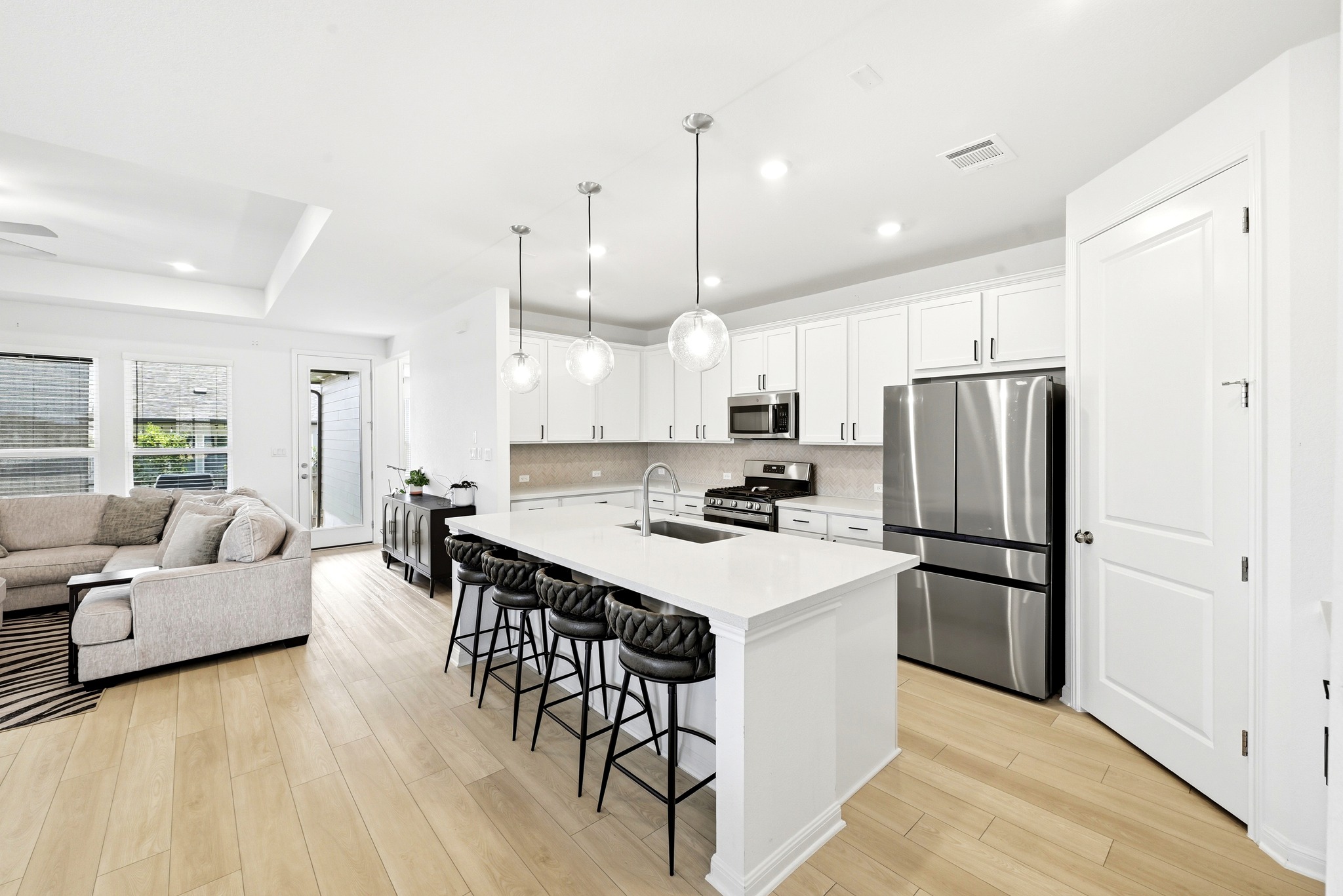 12401 Dairywork Road Buda, TX 78610 - Photo 11 of 28 Gleaming stone countertops and stainless steel appliances anchor this open-concept kitchen.