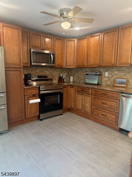 22 Karen Road Vernon, NJ 07422 - Photo 16 of 26 a kitchen with stainless steel appliances granite countertop a stove top oven a sink dishwasher a refrigerator and a microwave