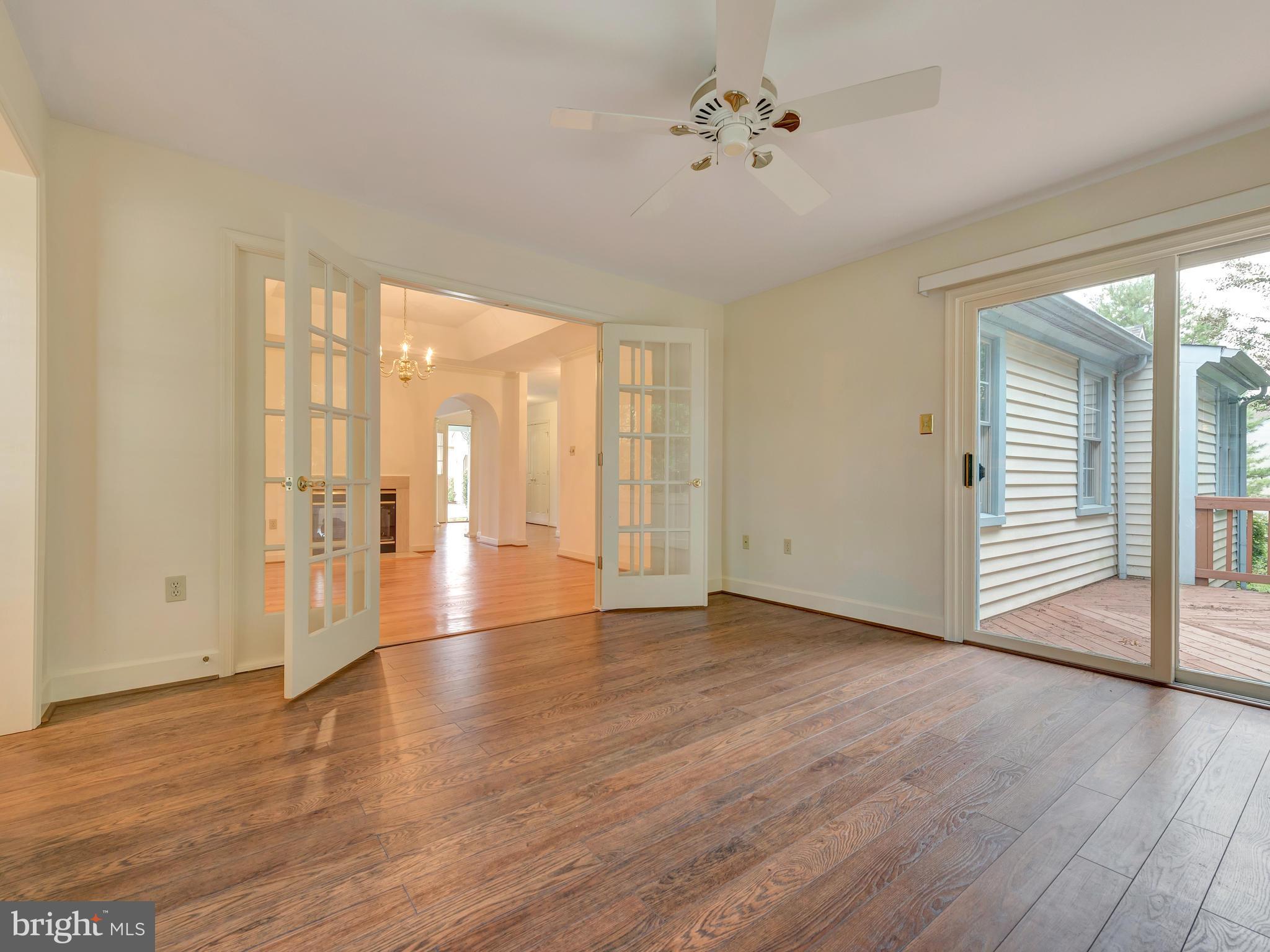 2447 Bear Den Road Frederick, MD 21701 - Photo 8 of 26 a view of an empty room with wooden floor and a window