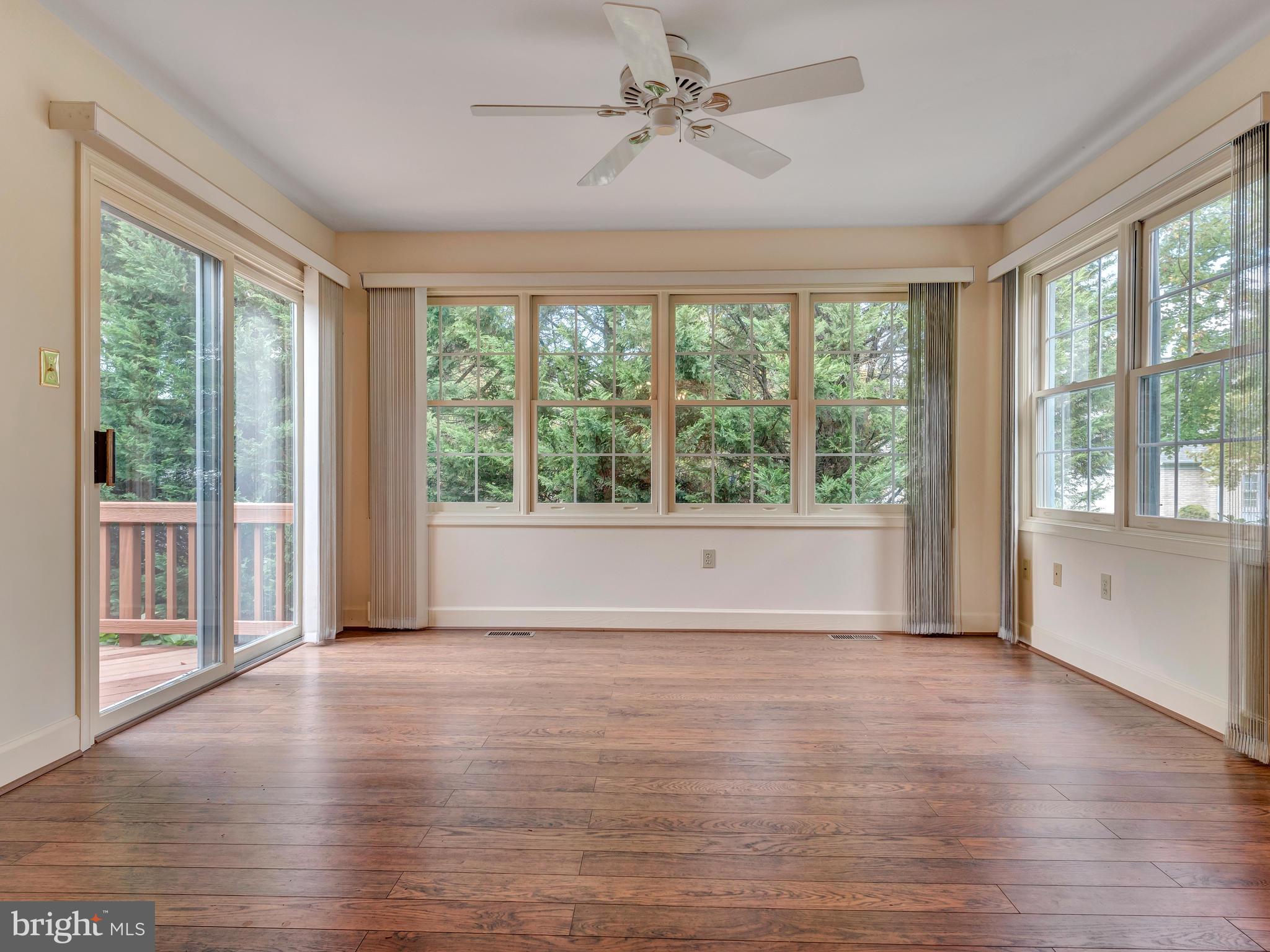2447 Bear Den Road Frederick, MD 21701 - Photo 9 of 26 a view of an empty room with wooden floor and a window