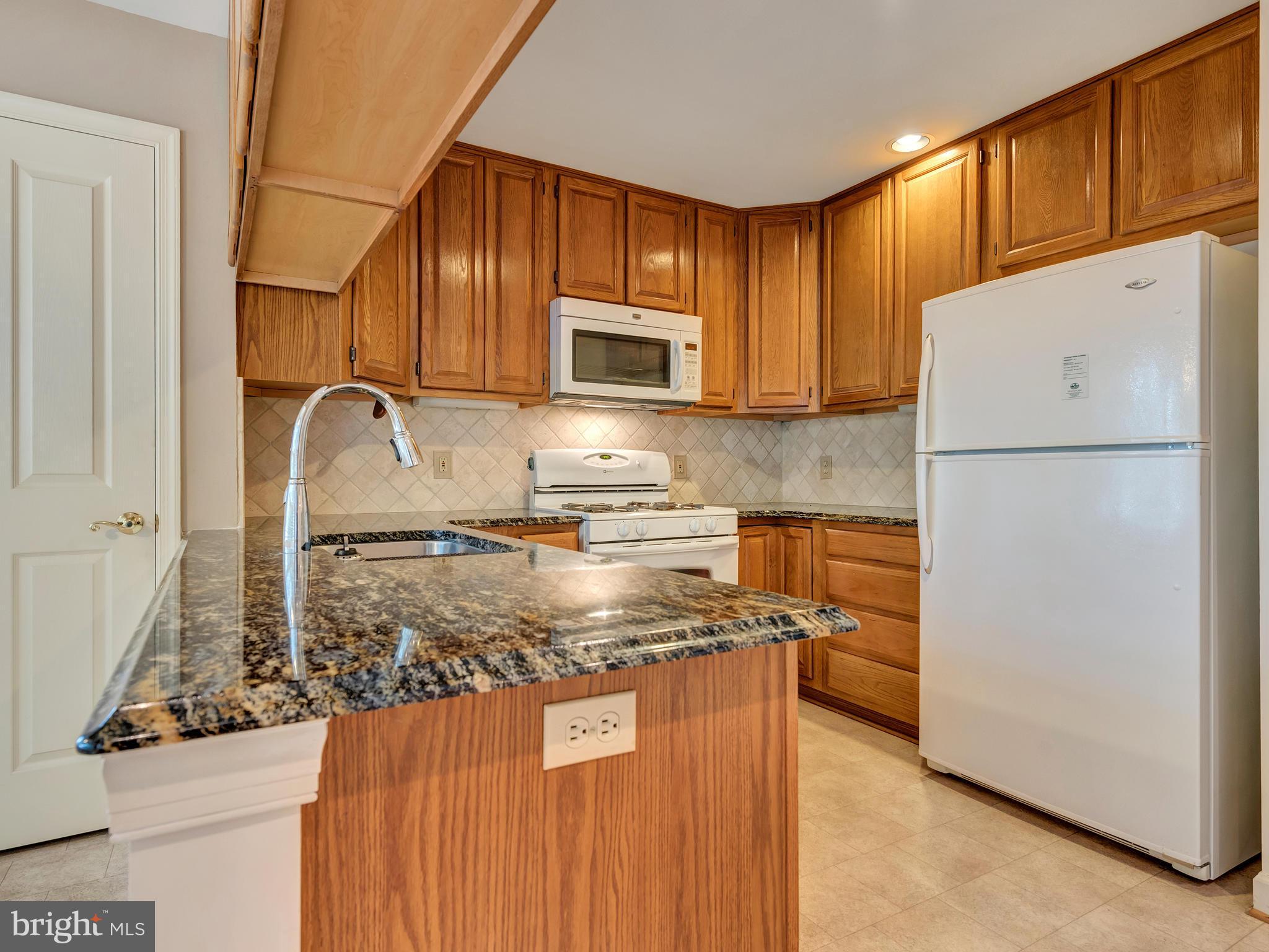2447 Bear Den Road Frederick, MD 21701 - Photo 10 of 26 a kitchen with granite countertop cabinets stainless steel appliances and a counter space