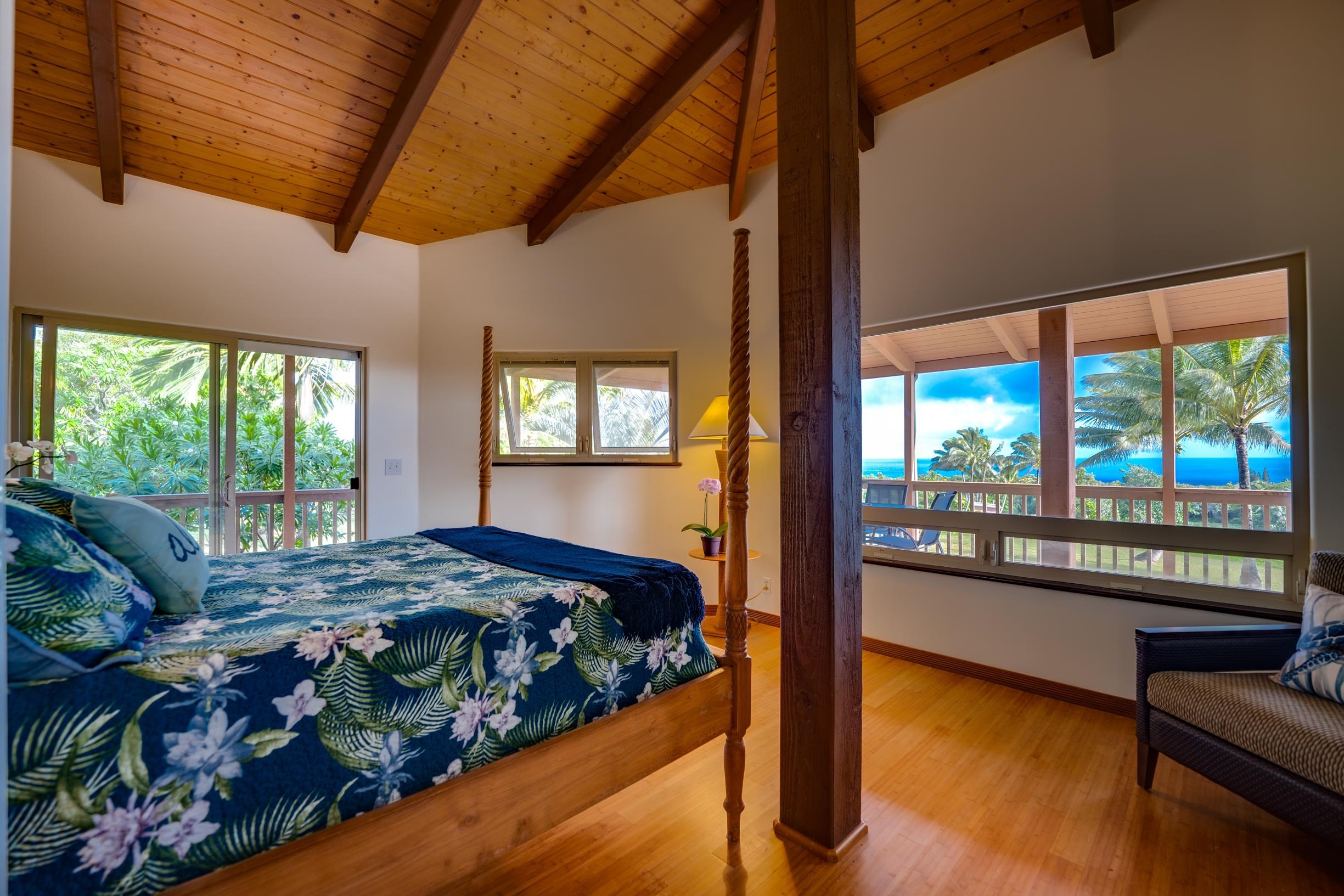 480 Puniawa Road Haiku, HI 96708 - Photo 19 of 30 a bed sitting in a bedroom next to a large window