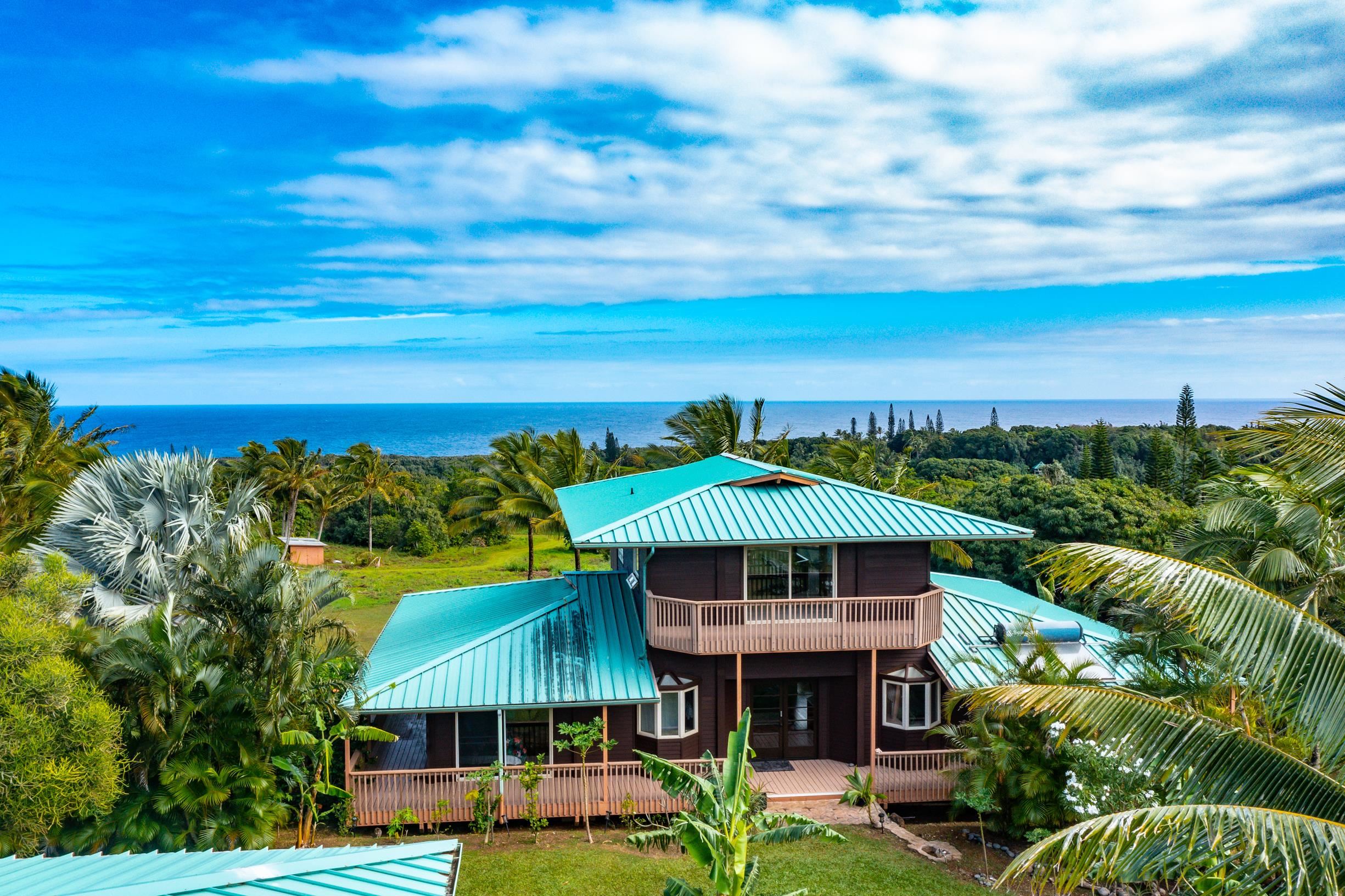 480 Puniawa Road Haiku, HI 96708 - Photo 7 of 30 a front view of a house with a yard