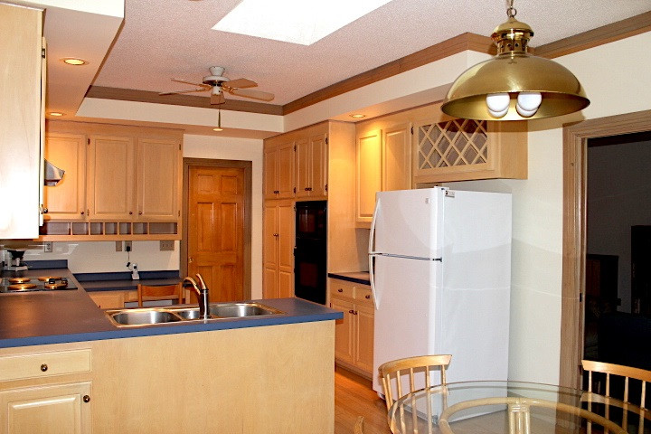 10700 Dunhill Terrace Raleigh, NC 27615 - Photo 7 of 16 Kitchen has a skylight, built-in microwave and wall oven. Thermador brand range hood has heat lamps to keep food warm. Kitchen