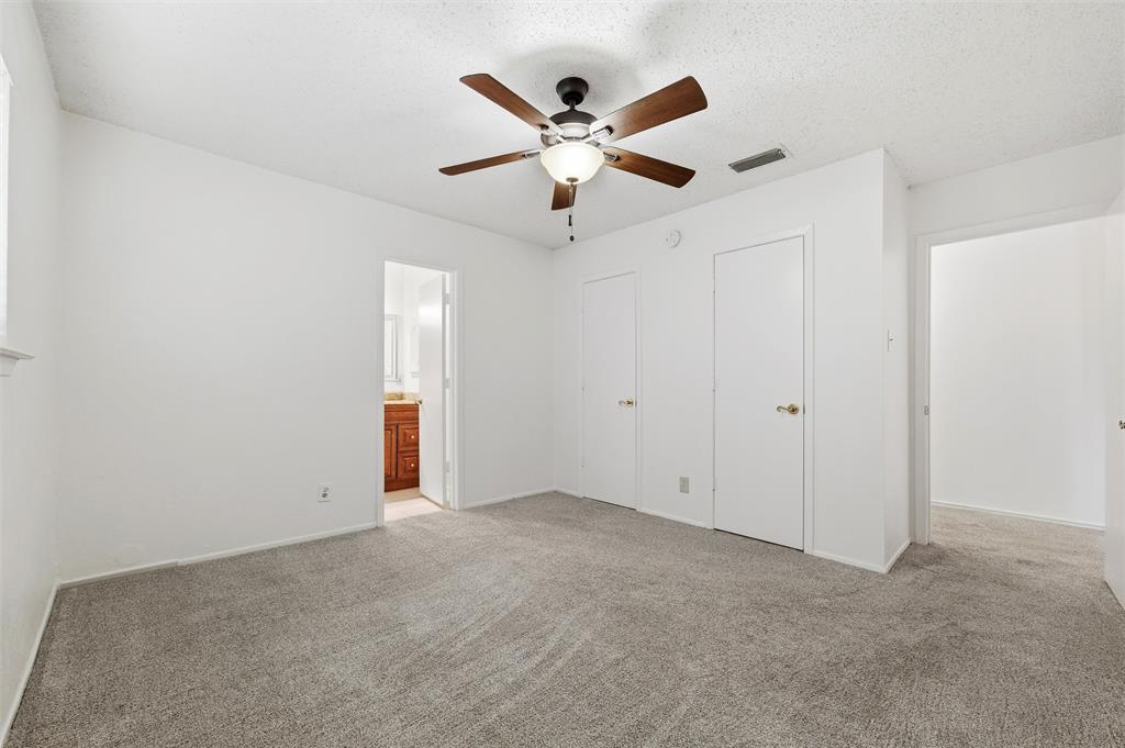 800 Howell Drive Coppell, TX 75019 - Photo 17 of 24 an empty room with closet and ceiling fan