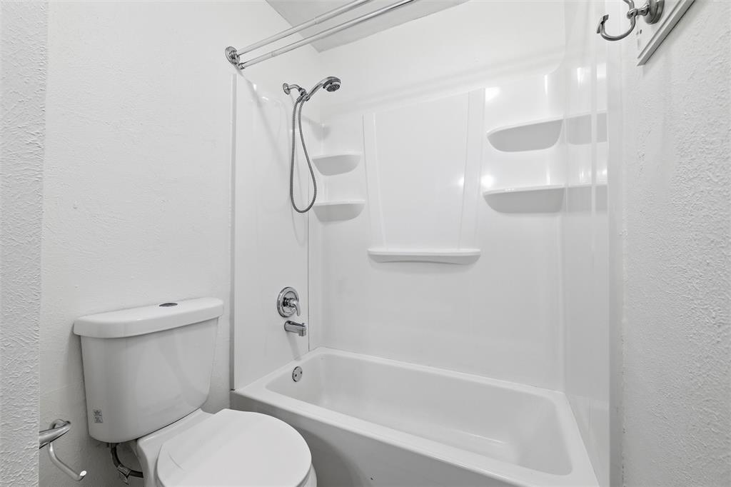 800 Howell Drive Coppell, TX 75019 - Photo 22 of 24 a bathroom with a toilet and a shower