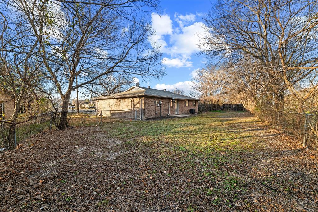 800 Howell Drive Coppell, TX 75019 - Photo 23 of 24 a yellow house sitting in middle of forest