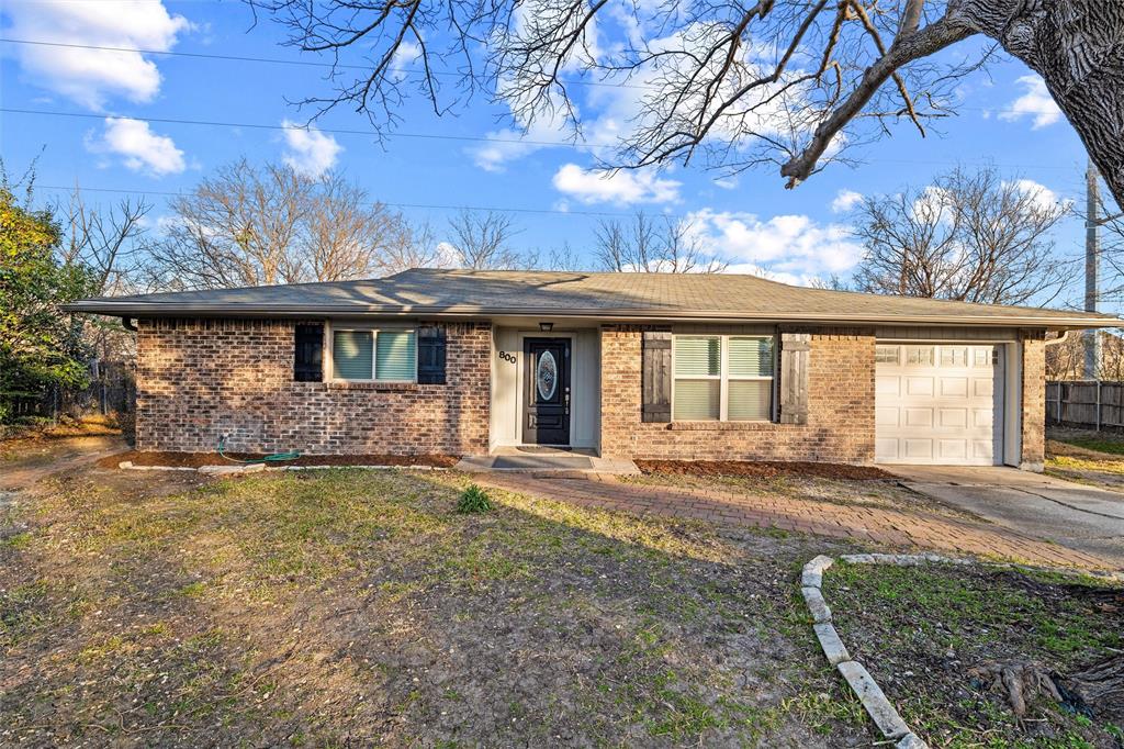 800 Howell Drive Coppell, TX 75019 - Photo 3 of 24 a front view of a house with a garden