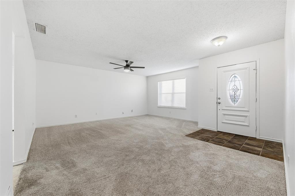 800 Howell Drive Coppell, TX 75019 - Photo 6 of 24 an empty room with windows and ceiling fan