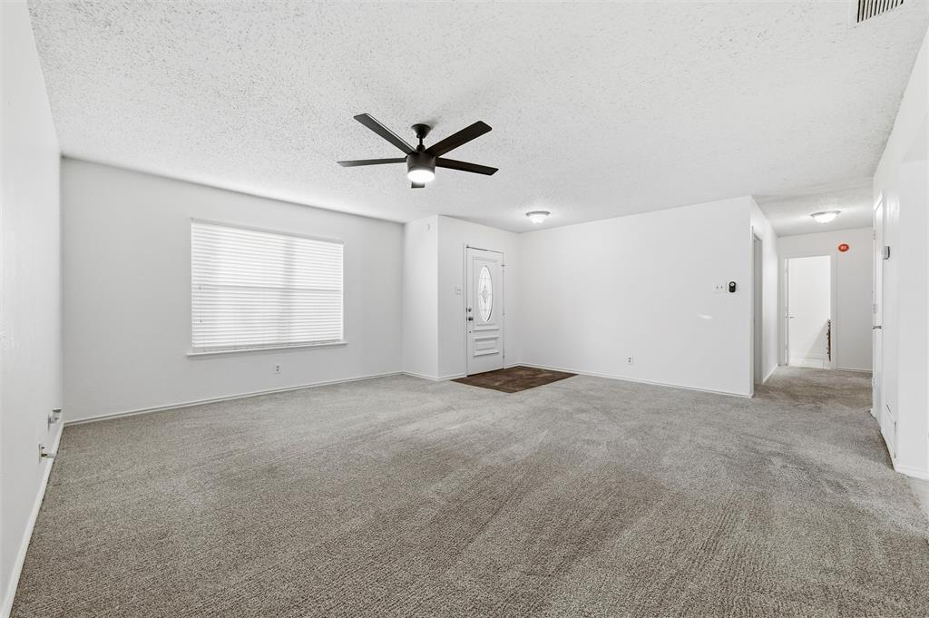 800 Howell Drive Coppell, TX 75019 - Photo 7 of 24 an empty room with a empty space and windows