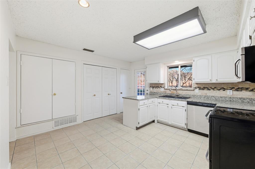 800 Howell Drive Coppell, TX 75019 - Photo 10 of 24 a kitchen with granite countertop white cabinets white appliances with a sink and dishwasher