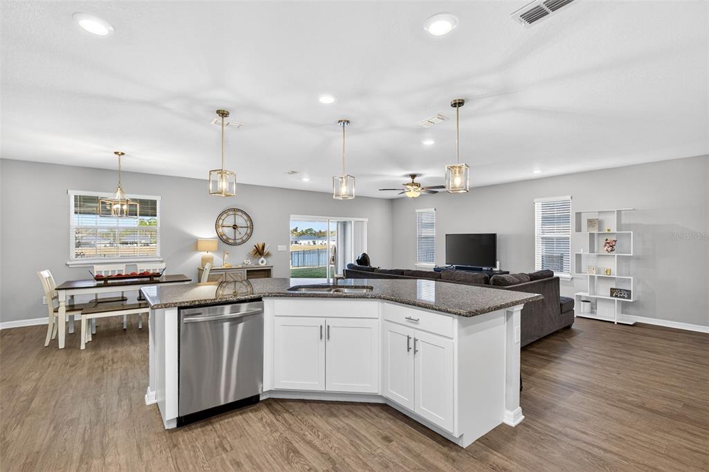 82 Berlin Avenue St. Cloud, FL 34771 - Photo 14 of 44 a kitchen with a sink stove and cabinets