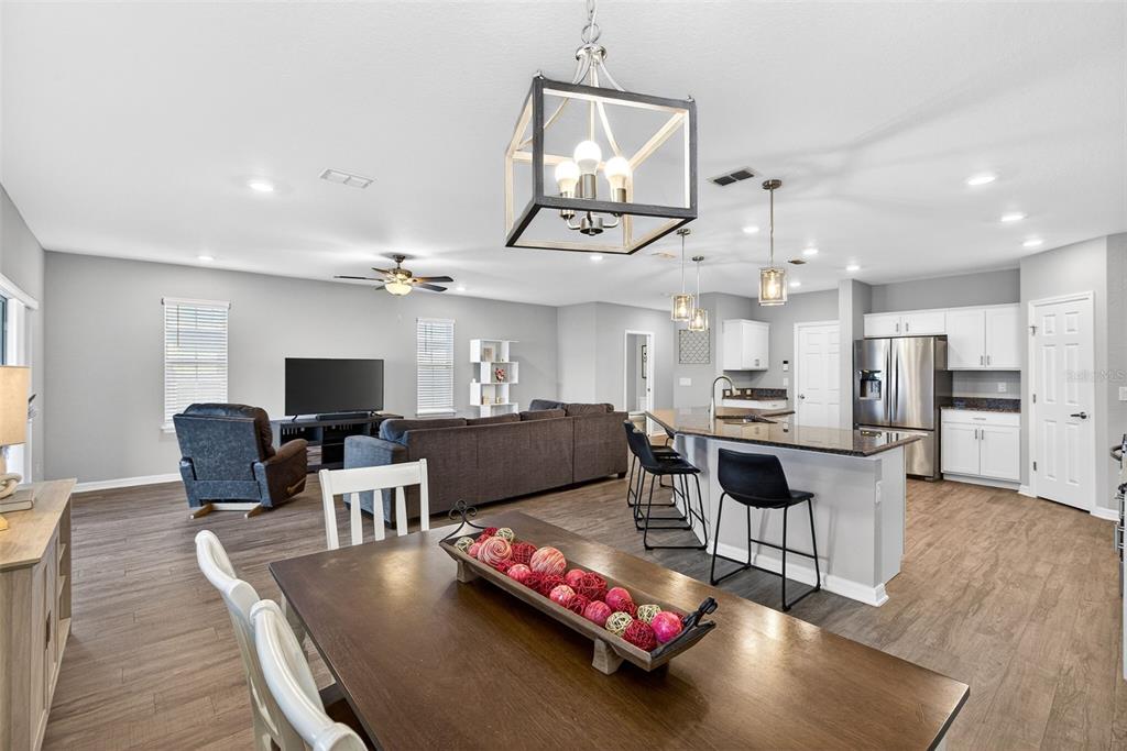82 Berlin Avenue St. Cloud, FL 34771 - Photo 17 of 44 a living room with furniture kitchen view and a wooden floor