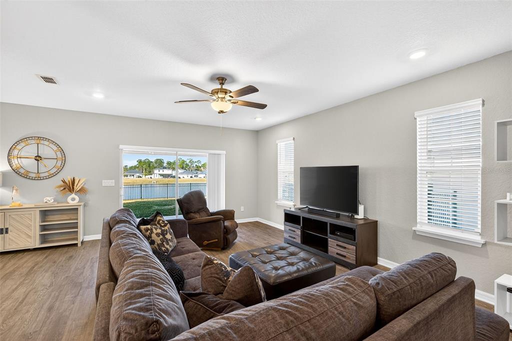 82 Berlin Avenue St. Cloud, FL 34771 - Photo 18 of 44 a living room with furniture and a flat screen tv