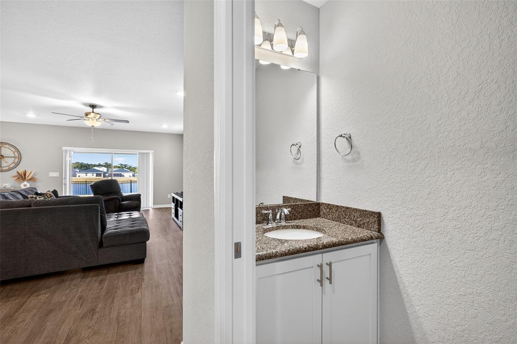 82 Berlin Avenue St. Cloud, FL 34771 - Photo 19 of 44 a en suite bathroom with a sink and mirror