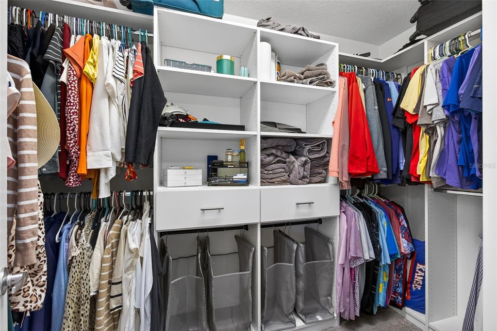 82 Berlin Avenue St. Cloud, FL 34771 - Photo 24 of 44 a view of walk in closet with clothes and shoes