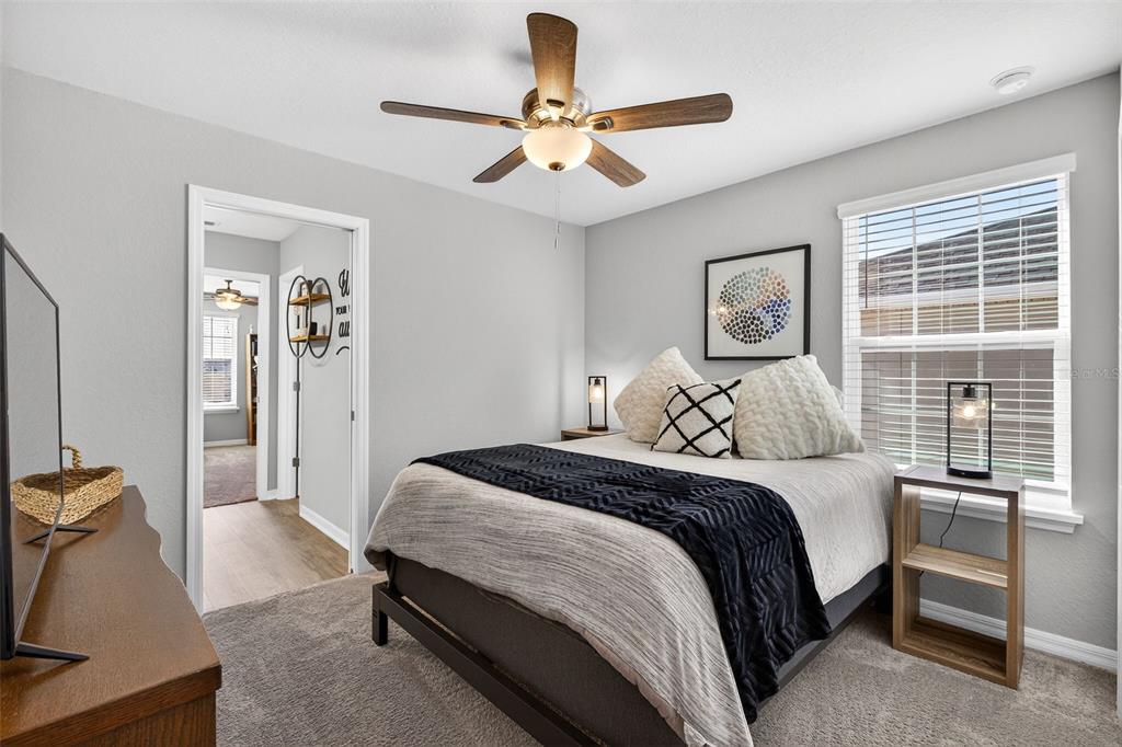 82 Berlin Avenue St. Cloud, FL 34771 - Photo 28 of 44 a bedroom with a bed and a large window