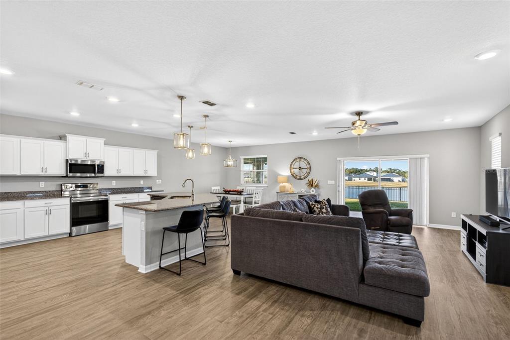 82 Berlin Avenue St. Cloud, FL 34771 - Photo 10 of 44 a living room with kitchen island furniture and kitchen view