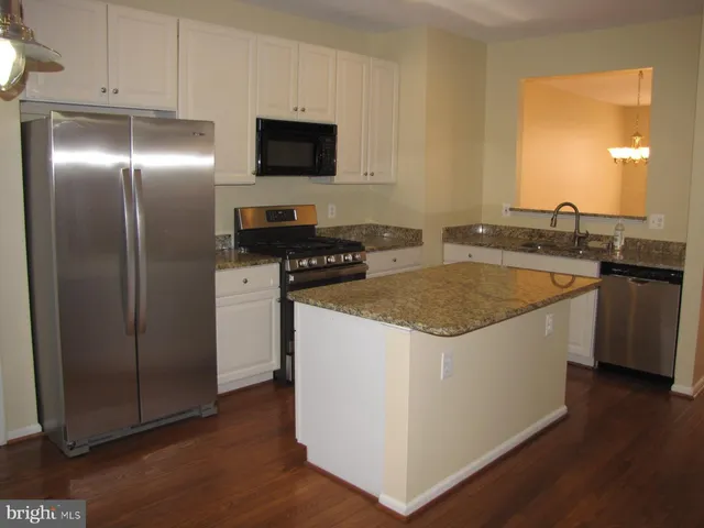 a kitchen that has a sink and a stove in it