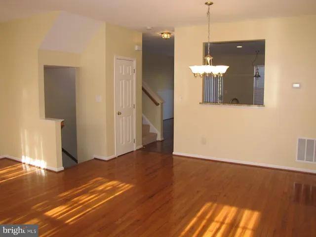 a view of a room with wooden floor and staircase
