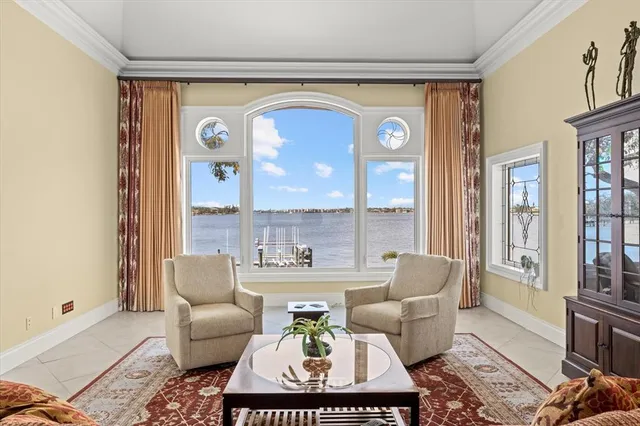 a kitchen with stainless steel appliances granite countertop a stove a sink a refrigerator and white cabinets with wooden floor