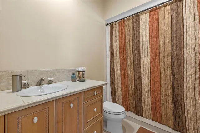 an aerial view of ocean and residential houses with outdoor space