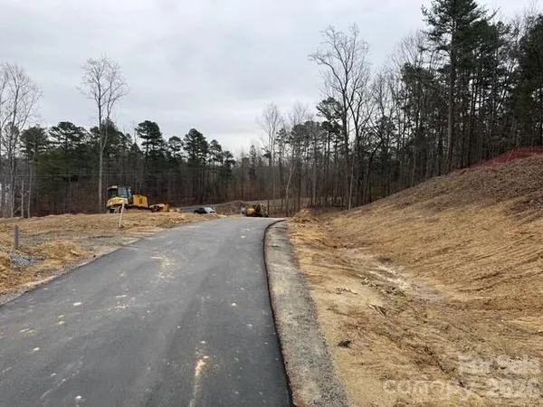 a view of a yard with wooden fence