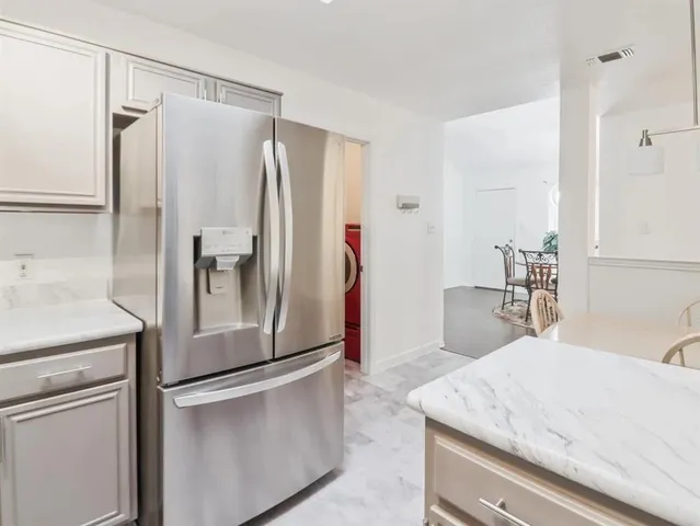 a kitchen with stainless steel appliances granite countertop a refrigerator and a sink