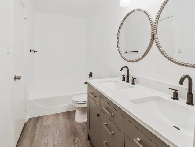 a bathroom with a sink a toilet and a mirror