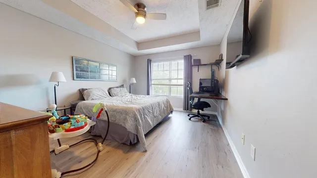 a bedroom with a bed and a flat screen tv