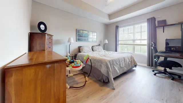 a bedroom with a bed and a window