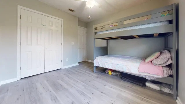 a bedroom with a bed and a potted plant