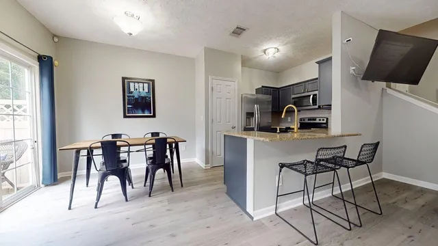 a dining room with furniture and a window