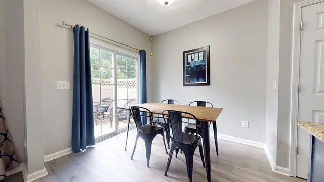 a view of a dining room with furniture and window